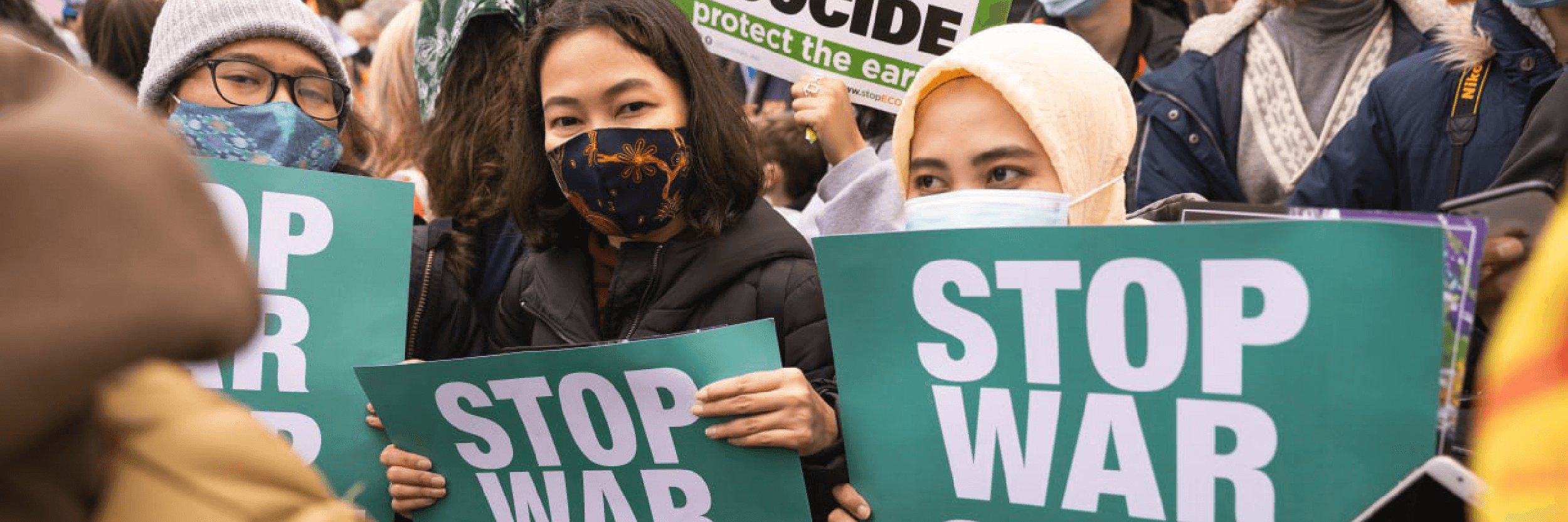 Protesters holding a 'stop war' posters